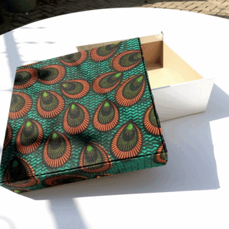 Present your gifts in style with our Gift Box featuring a Kitenge top and white button Ankara design. Perfect for adding a unique African touch to your gift-giving, this beautifully crafted box is ideal for special occasions. Elevate your gifting experience with this vibrant, handcrafted design. Order now!
